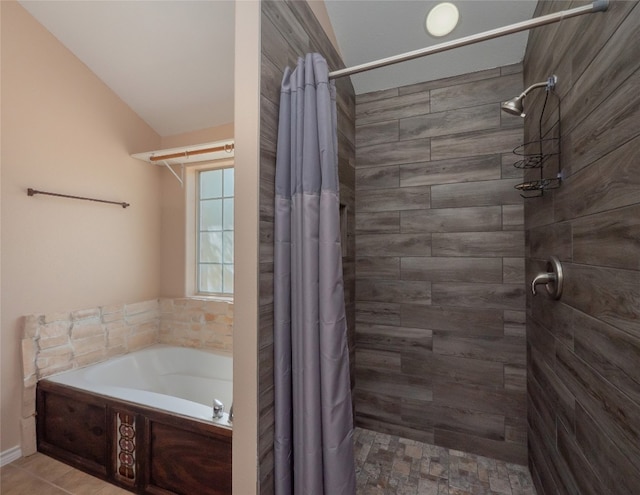 bathroom featuring shower with separate bathtub and vaulted ceiling