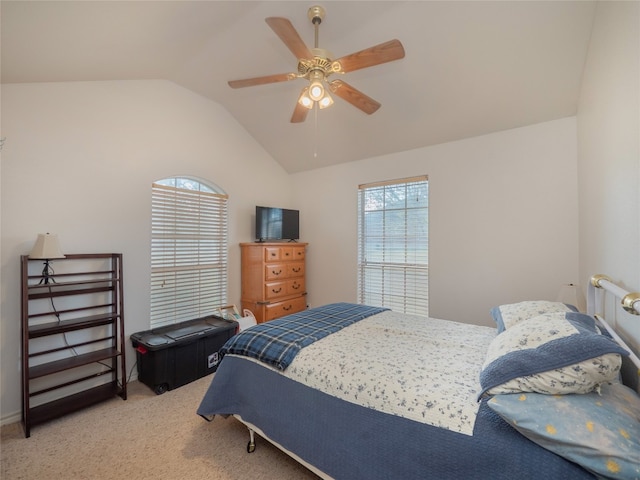 bedroom featuring ceiling fan, carpet floors, and vaulted ceiling