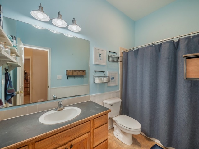 bathroom featuring walk in shower, tile patterned floors, vanity, and toilet