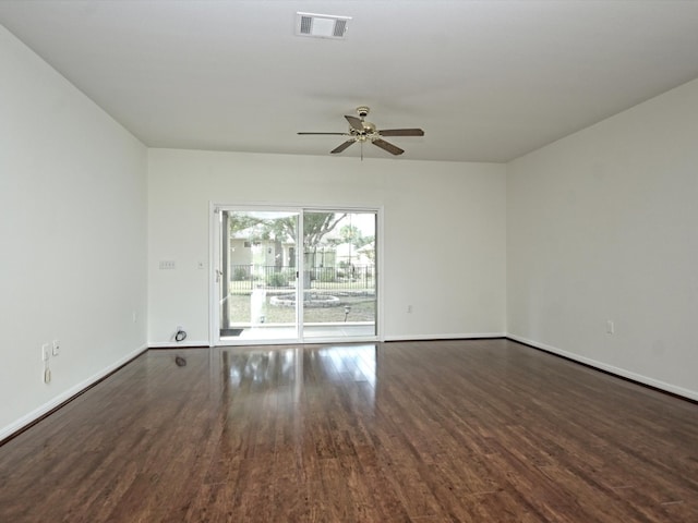 unfurnished room with ceiling fan and dark hardwood / wood-style flooring