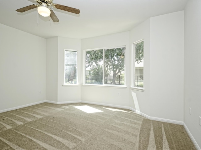 empty room featuring ceiling fan and carpet floors