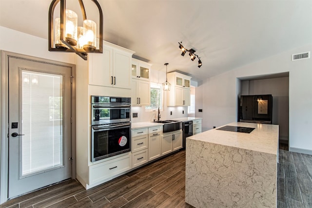 kitchen featuring hanging light fixtures, white cabinetry, black appliances, lofted ceiling, and dark hardwood / wood-style floors