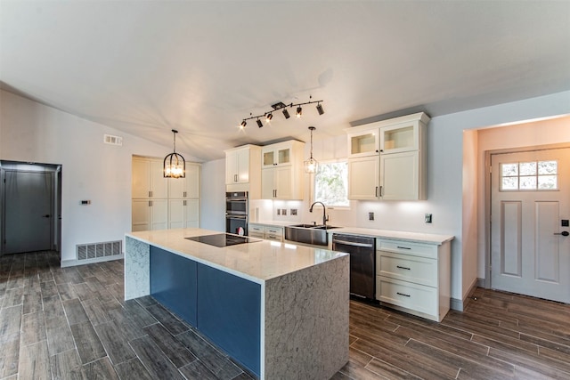 kitchen featuring a wealth of natural light, appliances with stainless steel finishes, dark hardwood / wood-style floors, and a kitchen island