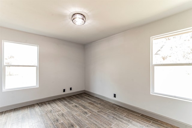 unfurnished room with light hardwood / wood-style flooring and a wealth of natural light