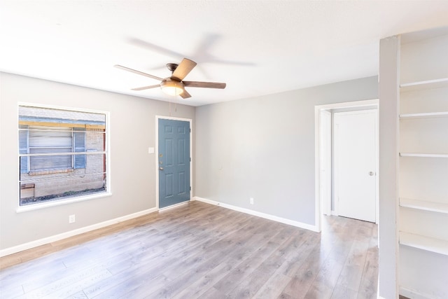 unfurnished room with light wood-type flooring and ceiling fan