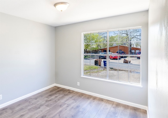 spare room with light hardwood / wood-style flooring and a healthy amount of sunlight