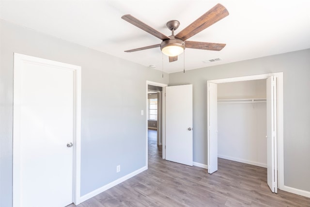 unfurnished bedroom with ceiling fan, a closet, and light hardwood / wood-style floors