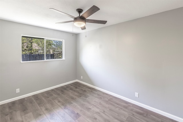 spare room with hardwood / wood-style floors and ceiling fan