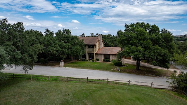 rear view of property with a lawn and a rural view