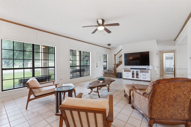 living room featuring crown molding, a healthy amount of sunlight, and ceiling fan