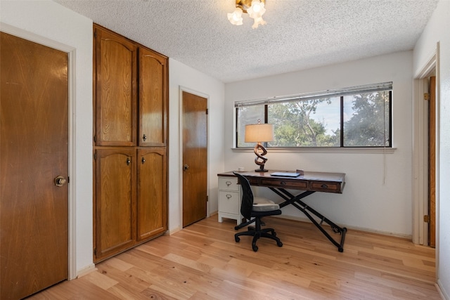 office featuring light hardwood / wood-style floors and a textured ceiling