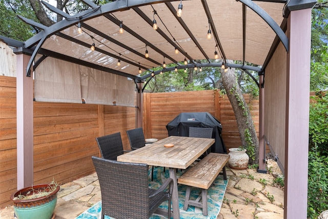 view of patio featuring grilling area and a pergola