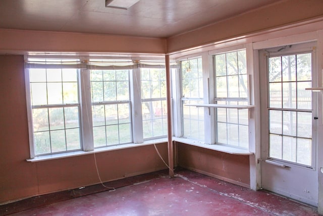 unfurnished sunroom featuring a wealth of natural light