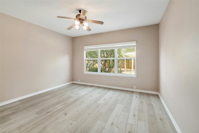 spare room featuring light wood-type flooring and ceiling fan