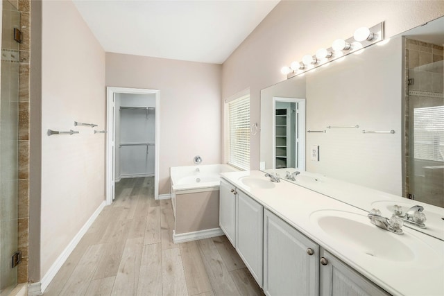 bathroom with vanity, hardwood / wood-style flooring, and shower with separate bathtub