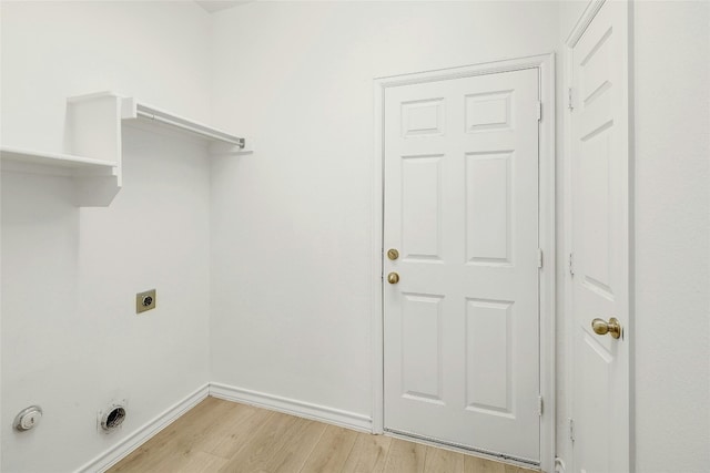 laundry room with light hardwood / wood-style flooring and hookup for an electric dryer