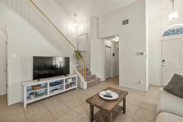 tiled living room with a high ceiling