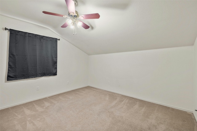 additional living space featuring light carpet, ceiling fan, and vaulted ceiling