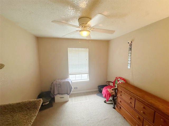 interior space featuring ceiling fan and a textured ceiling