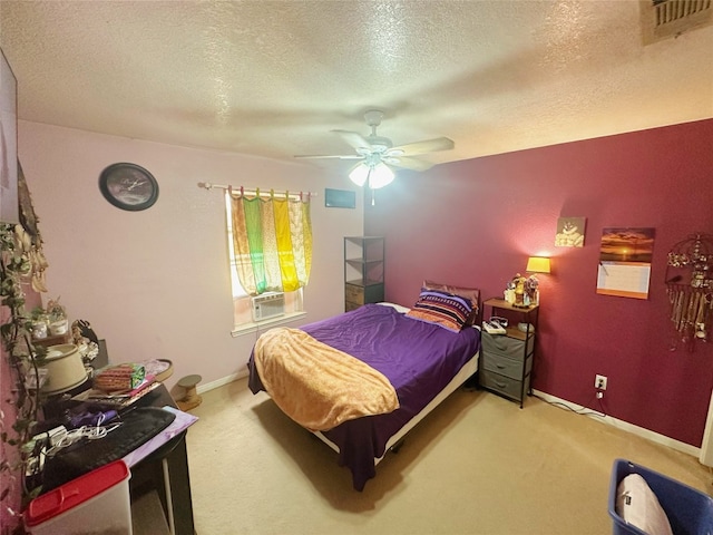 bedroom featuring a textured ceiling, cooling unit, carpet flooring, and ceiling fan