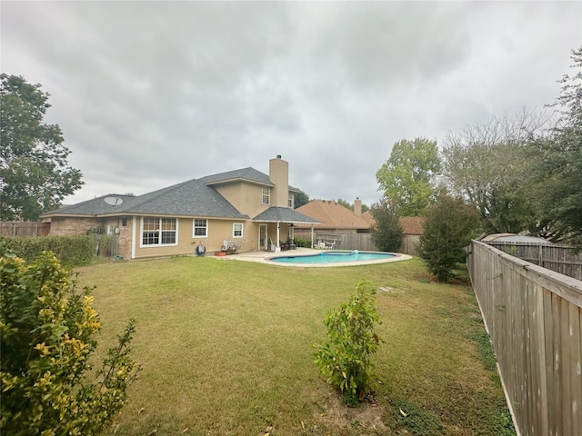 exterior space with a fenced in pool, a patio area, and a yard