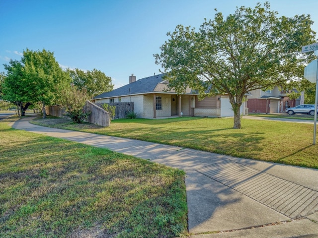 view of front of property featuring a front yard and a garage