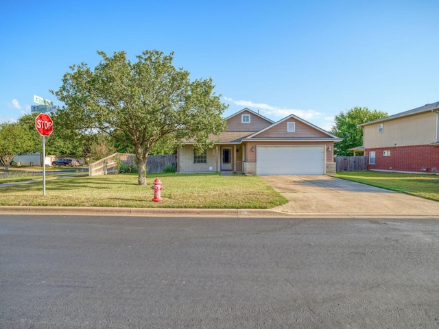 view of front of house featuring a garage and a front lawn