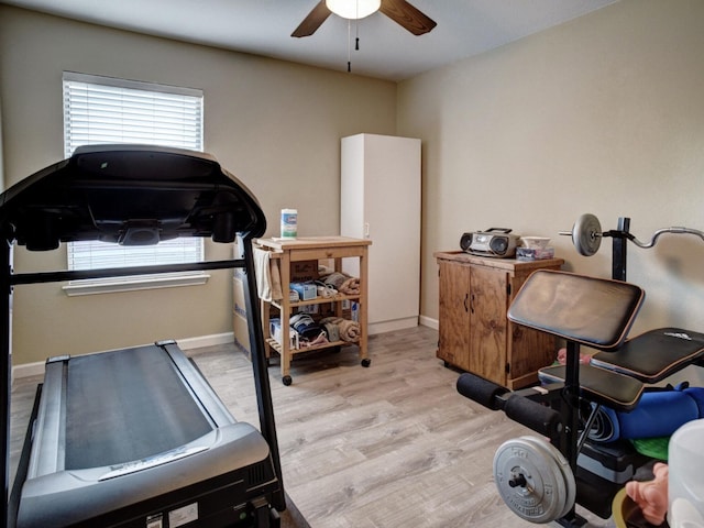 workout room with ceiling fan and light hardwood / wood-style flooring