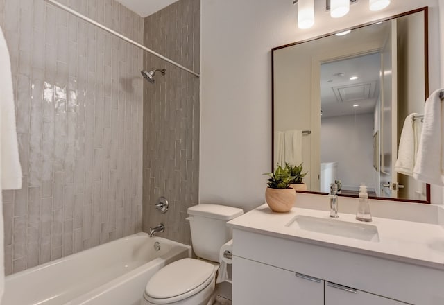 full bathroom featuring toilet, vanity, and tiled shower / bath