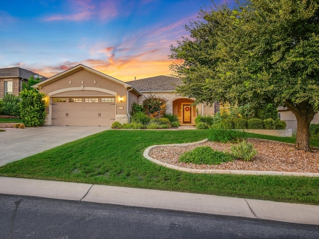 view of front of house with a lawn and a garage