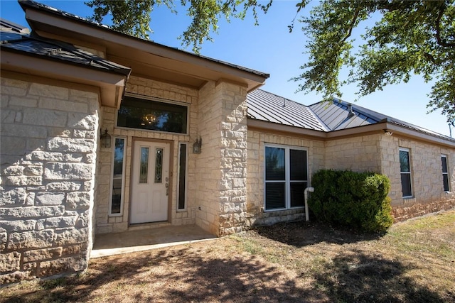 13639 Abrahamson Rd, Manor, TX 78653 - doorway to property with stone siding, a metal roof, and a standing seam roof