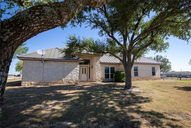 13639 Abrahamson Rd, Manor, TX 78653 - rear view of property with stone siding, a metal roof, and a standing seam roof