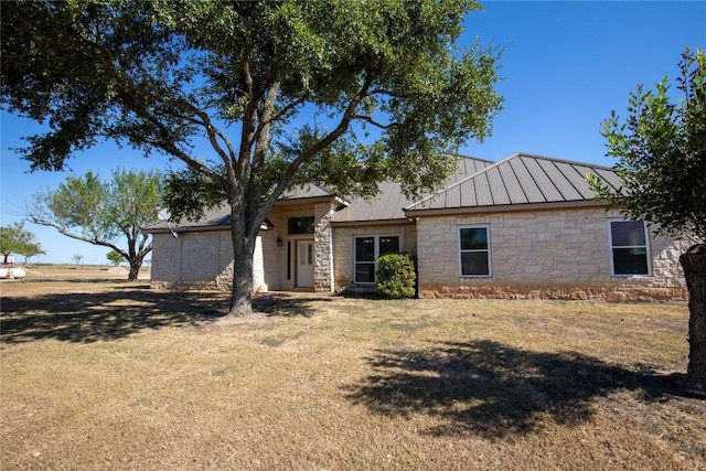 13639 Abrahamson Rd, Manor, TX 78653 - view of front of property featuring stone siding, a front lawn, and metal roof
