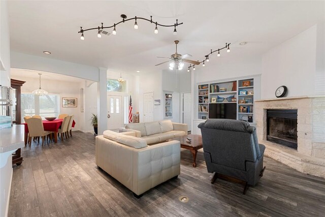 13639 Abrahamson Rd, Manor, TX 78653 - living area with ceiling fan, a stone fireplace, wood finished floors, and rail lighting