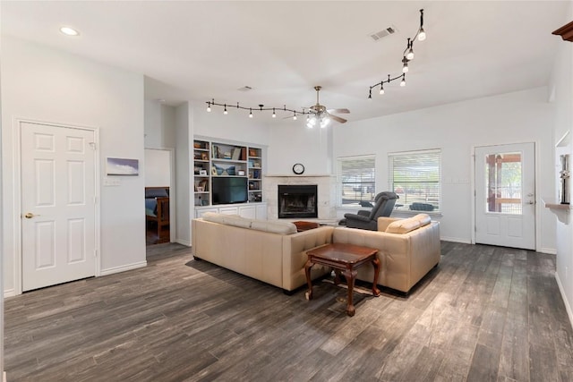 13639 Abrahamson Rd, Manor, TX 78653 - living room with ceiling fan, dark wood finished floors, a fireplace, rail lighting, and recessed lighting