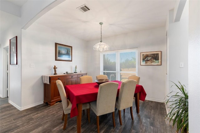 13639 Abrahamson Rd, Manor, TX 78653 - dining space with dark wood-type flooring, a chandelier, and arched walkways