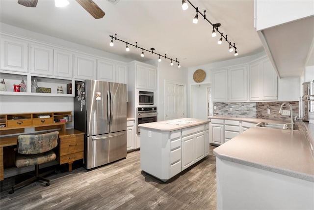 13639 Abrahamson Rd, Manor, TX 78653 - kitchen featuring appliances with stainless steel finishes, a sink, and white cabinets