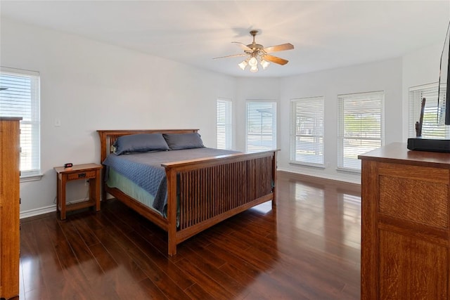 13639 Abrahamson Rd, Manor, TX 78653 - bedroom with wood finished floors, multiple windows, baseboards, and ceiling fan