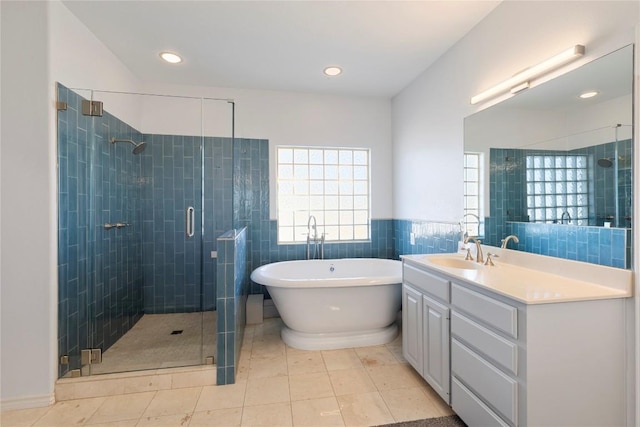 13639 Abrahamson Rd, Manor, TX 78653 - full bath with a stall shower, a freestanding tub, vanity, tile walls, and recessed lighting