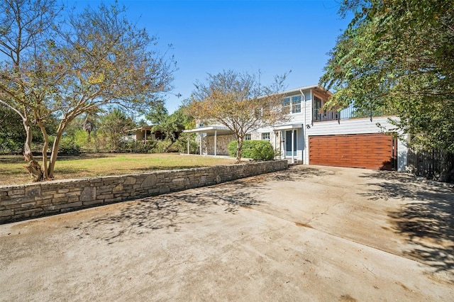 exterior space featuring a balcony and a front lawn