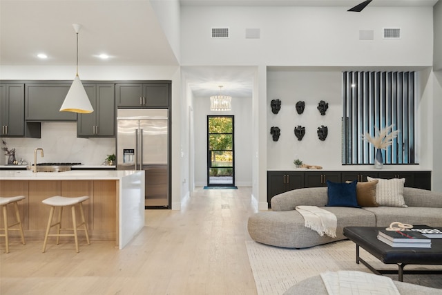 living room with a chandelier and light hardwood / wood-style floors