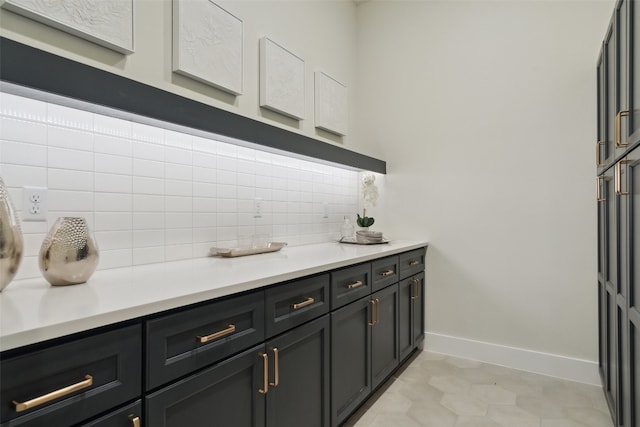 bar with light tile patterned floors and backsplash