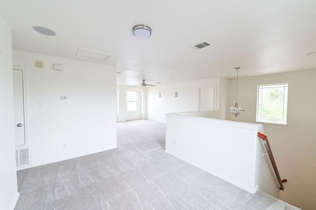 unfurnished room featuring ceiling fan and light carpet