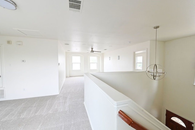 hallway with light carpet and plenty of natural light