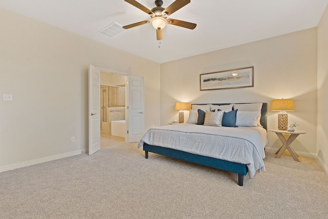 carpeted bedroom with ensuite bathroom and ceiling fan