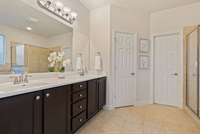 bathroom featuring tile patterned floors, walk in shower, and vanity