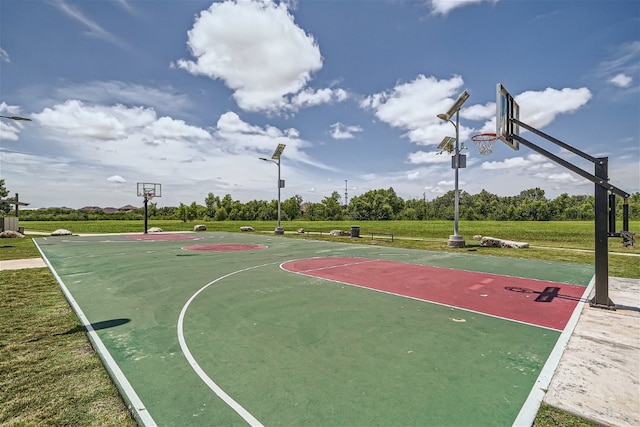 view of sport court featuring a yard