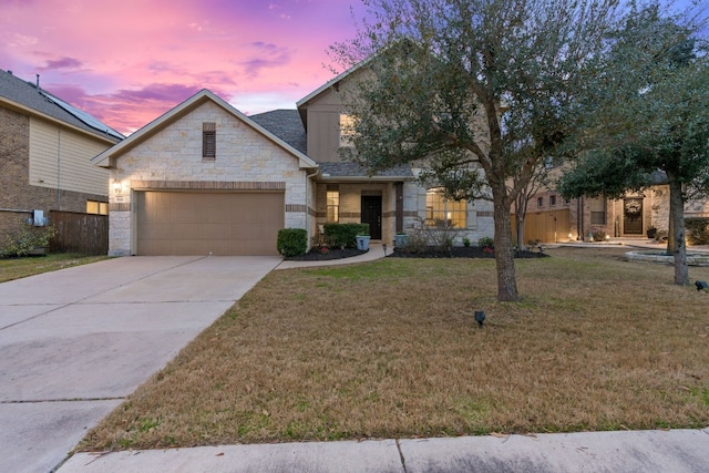 view of front of house featuring a lawn and a garage