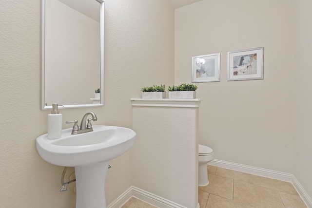 bathroom with tile patterned flooring and toilet