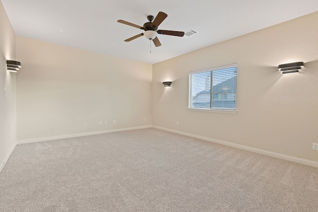 empty room with ceiling fan and carpet